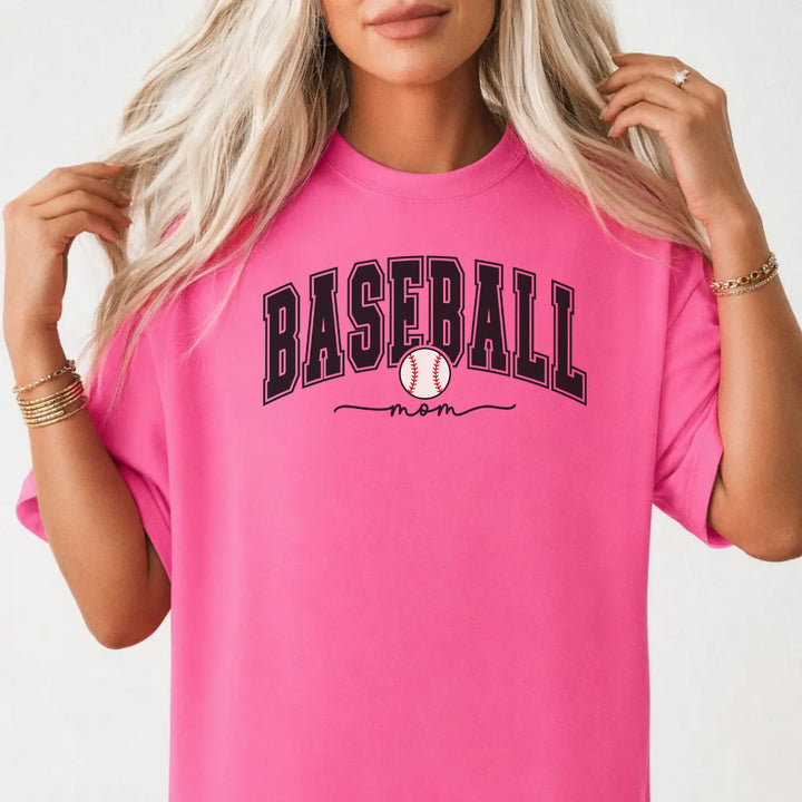 Woman wearing a neon pink shirt with bold varsity arched Baseball Mom lettering and a baseball graphic on the front