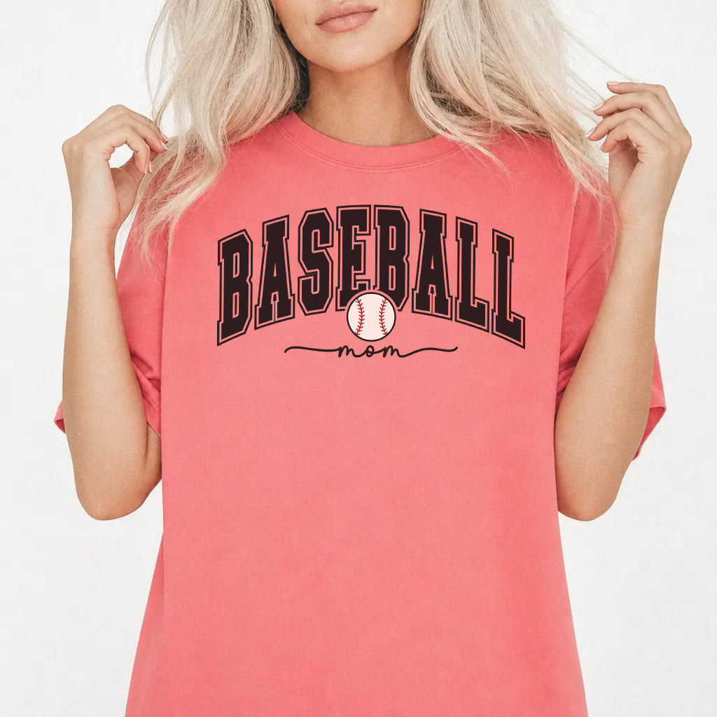 Woman wearing a watermelon shirt with bold varsity arched Baseball Mom lettering and a baseball graphic on the front