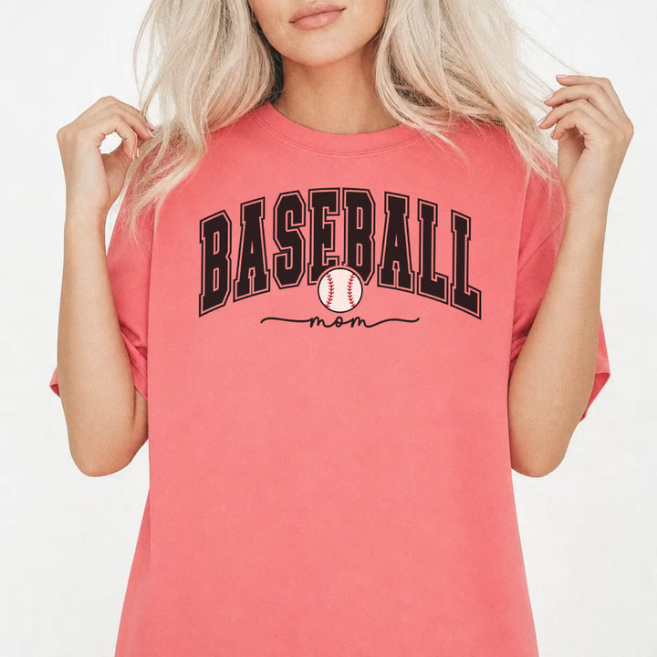 Woman wearing a watermelon shirt with bold varsity arched Baseball Mom lettering and a baseball graphic on the front