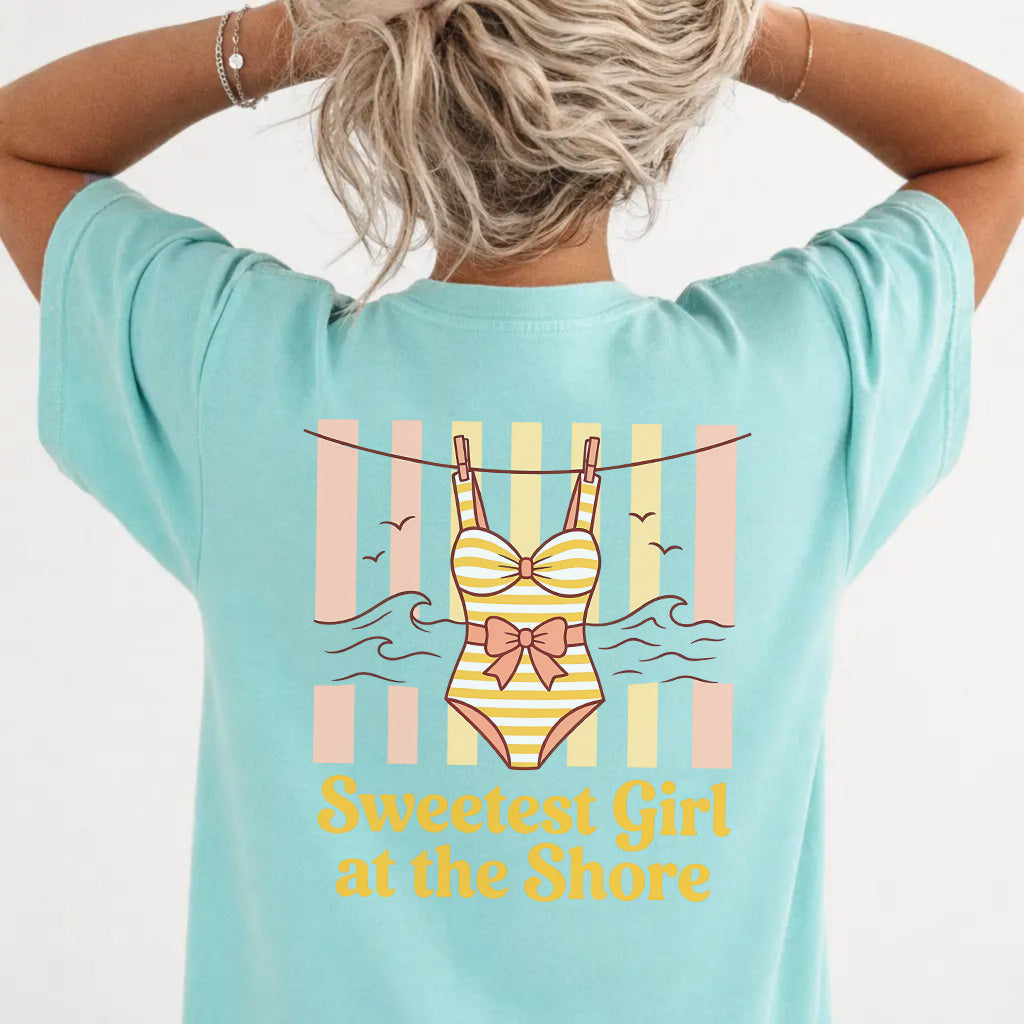 Woman wearing a chalky mint coastal cutie graphic tee with retro swimsuit clothesline back print