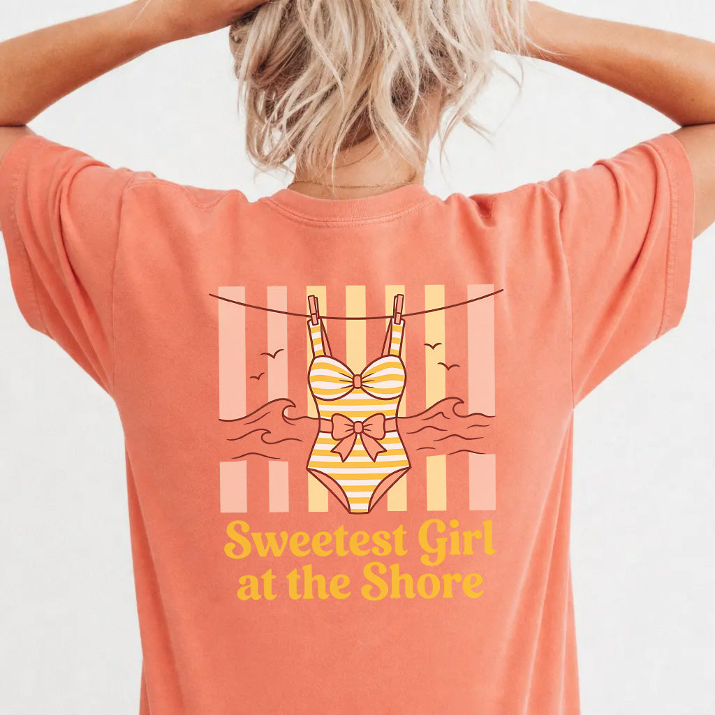 Woman wearing a terracotta coastal cutie graphic tee with retro swimsuit clothesline back print