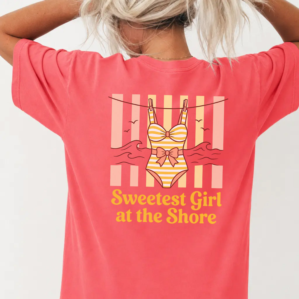 Woman wearing a watermelon red coastal cutie graphic tee with retro swimsuit clothesline back print