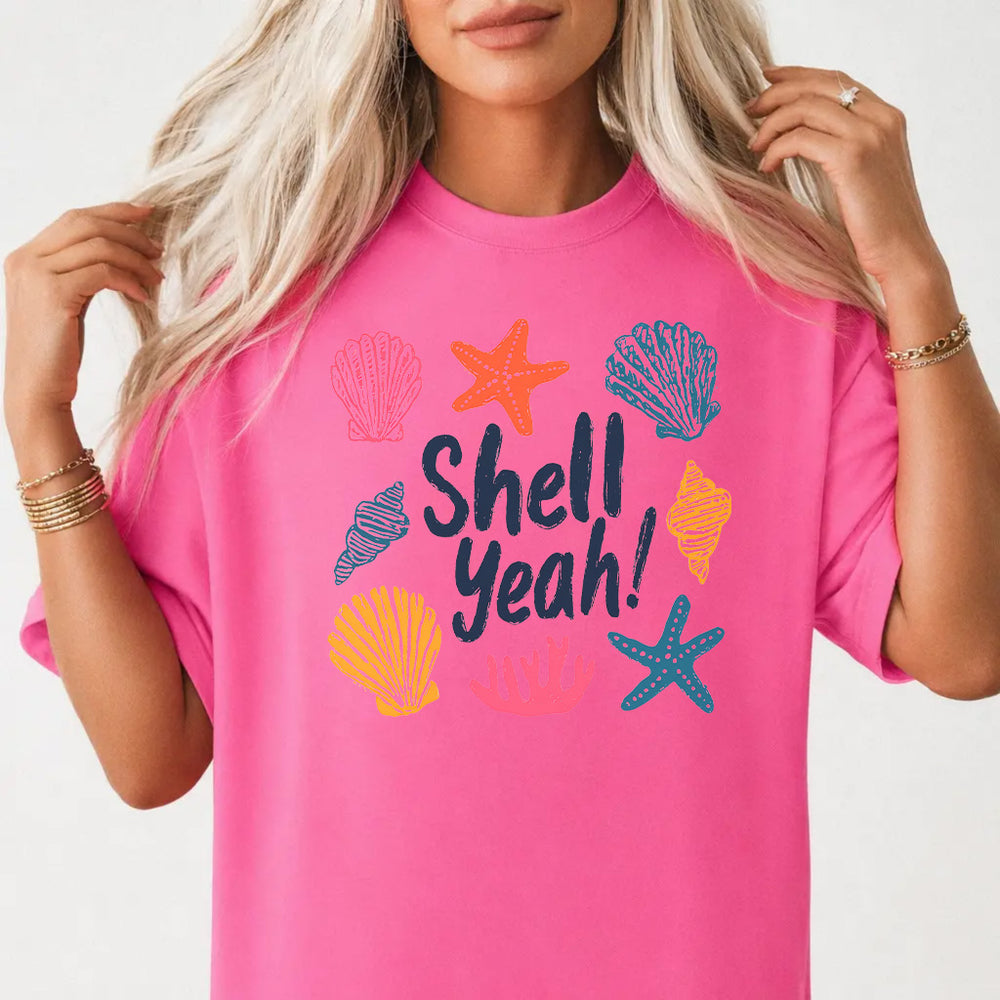 Woman wearing a neon pink cute beach coastal women's graphic tee with colorful seashells starfish and coral front print