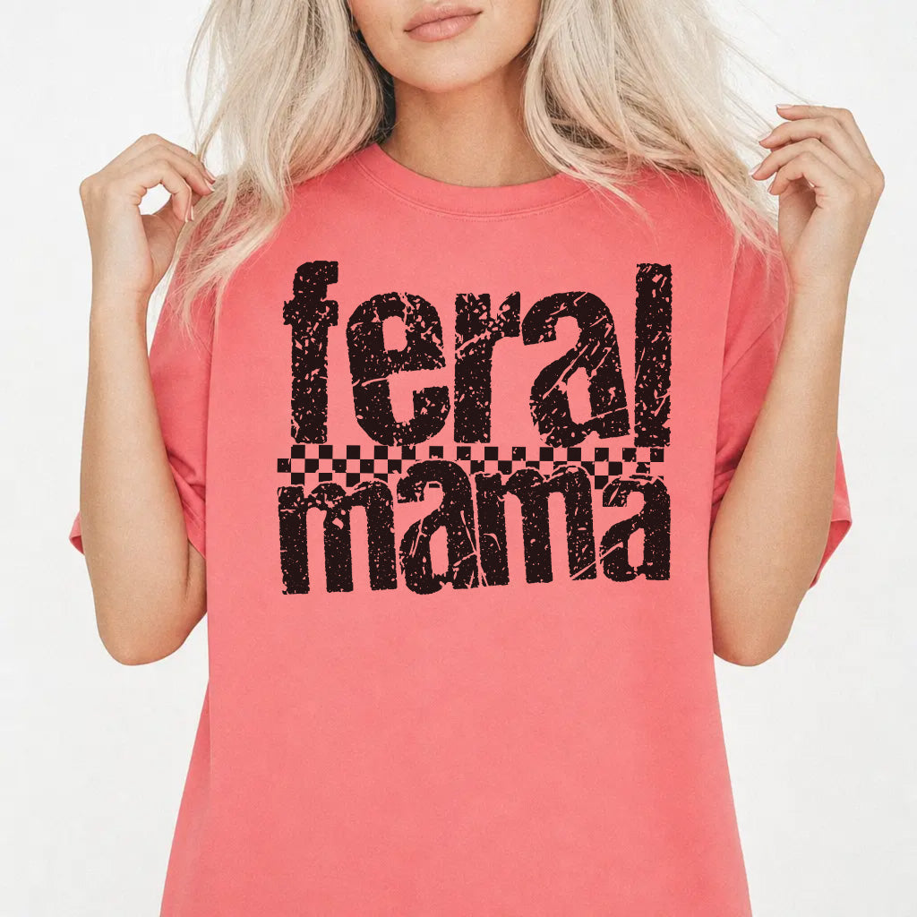 Woman wearing a watermelon shirt with bold distressed Feral Mama lettering and a checkered stripe accent on the front