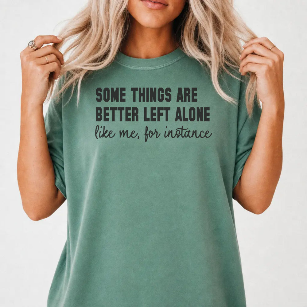 Woman wearing a light green funny antisocial humor women's graphic tee with bold block and cursive lettering, front print
