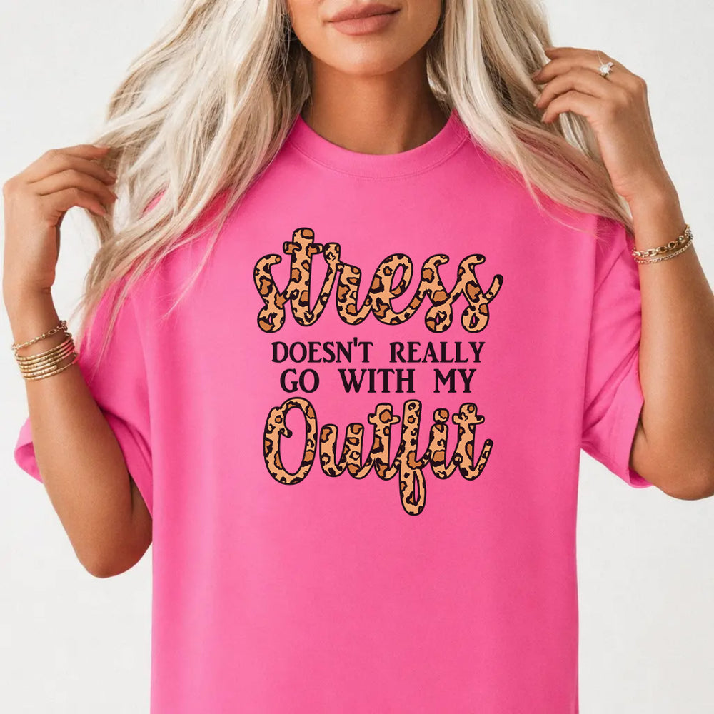 Woman wearing a neon pink funny leopard print women's graphic tee with bold leopard-filled lettering front print