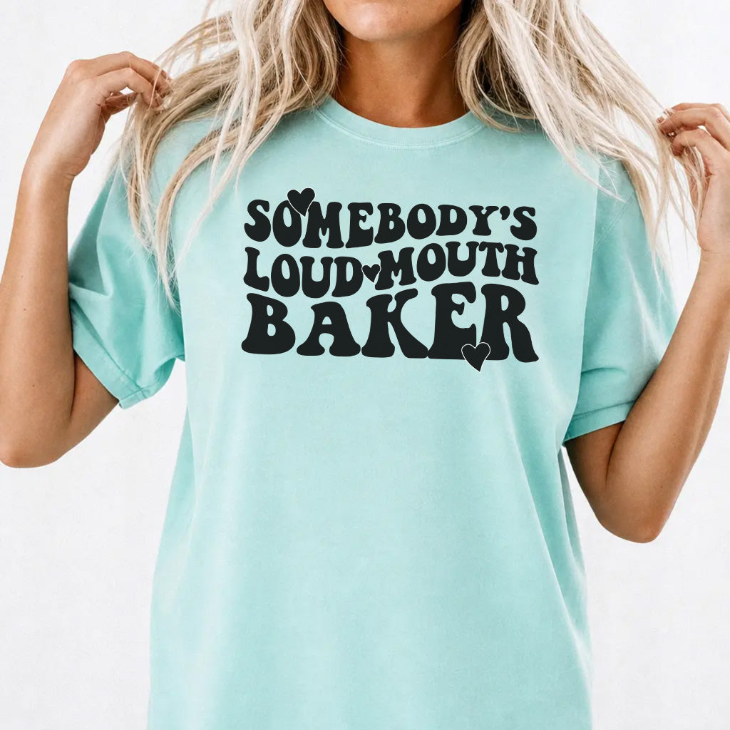 Woman wearing a chalky mint funny loud mouth baker women's graphic tee with retro wavy lettering and heart accents, front print