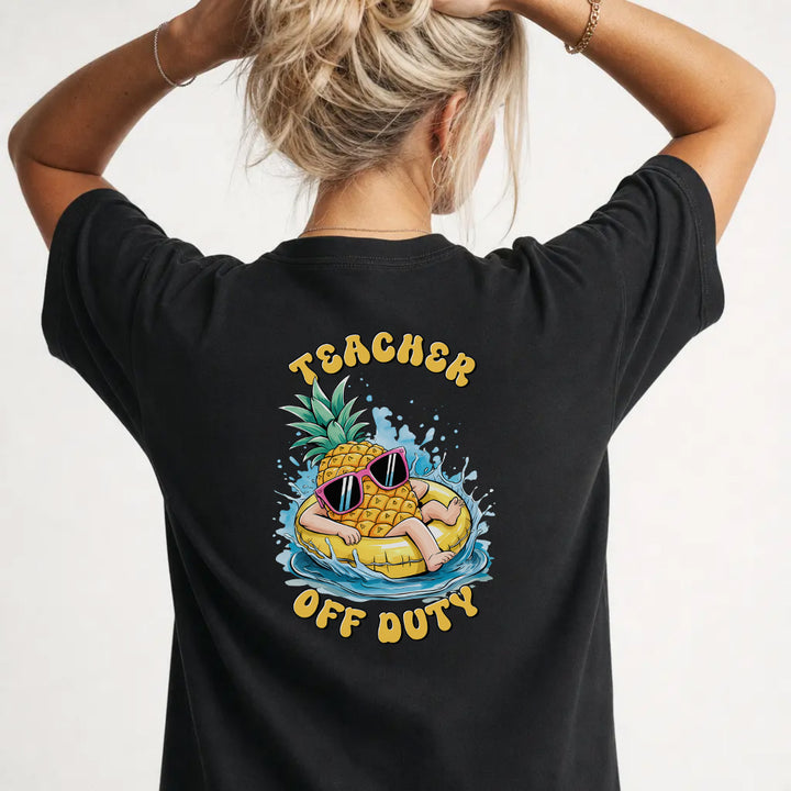 Woman wearing a black funny teacher graphic tee with pineapple pool float back print