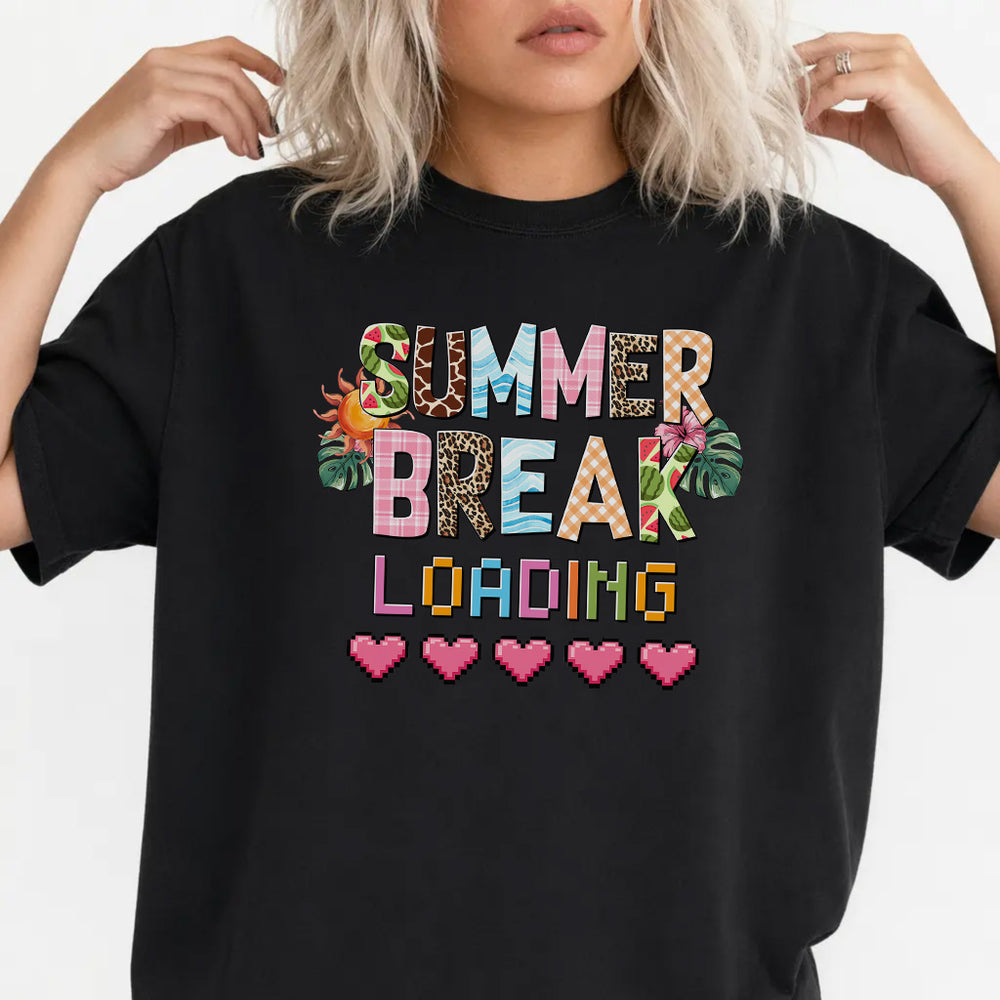 Woman wearing a black funny teacher summer women's graphic tee with colorful patterned lettering and pixel hearts front print