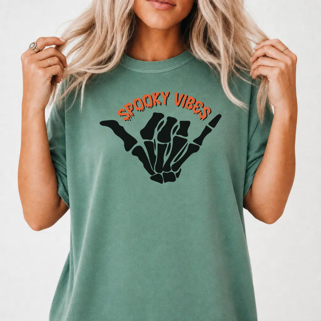 Woman wearing a light green halloween skeleton hand women&
