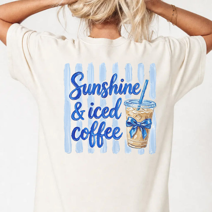 Woman wearing an ivory iced coffee lover graphic tee with painted coffee cup back print