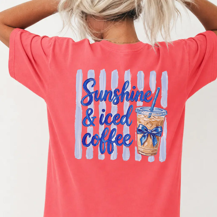 Woman wearing a watermelon red iced coffee lover graphic tee with painted coffee cup back print