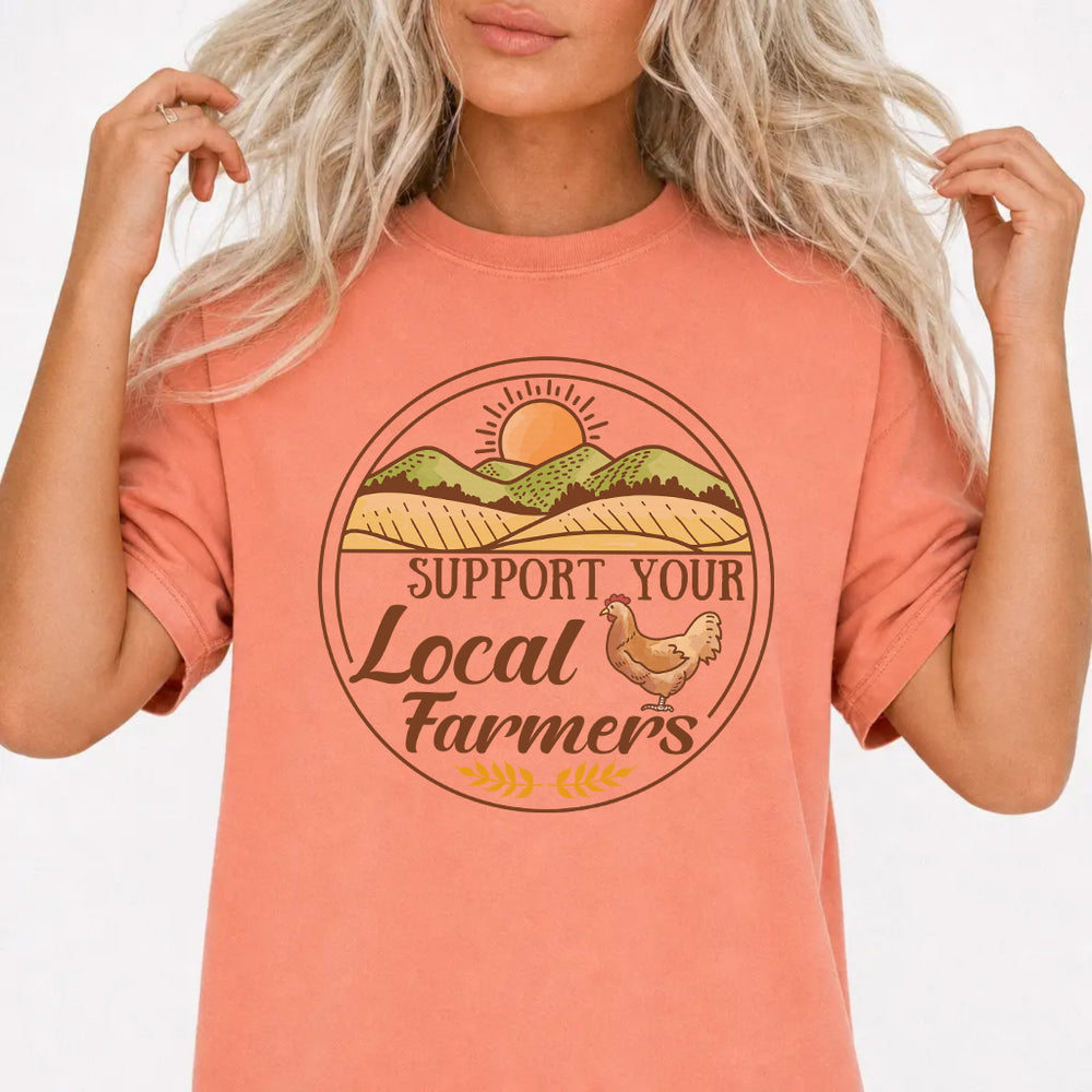 Woman wearing a terracotta local farmer chicken women's graphic tee with a vintage circular farm badge illustration, front print