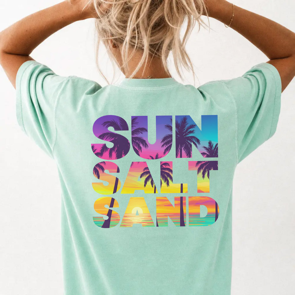 Woman wearing an island reef sunset beach graphic tee with colorful palm tree back print