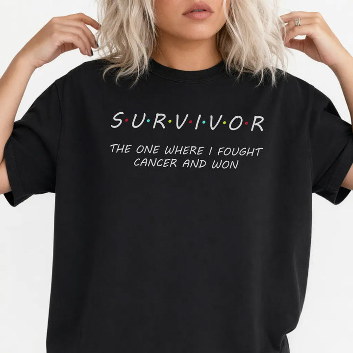 Woman wearing a black Survivor graphic tee that reads The One Where I Fought Cancer and Won