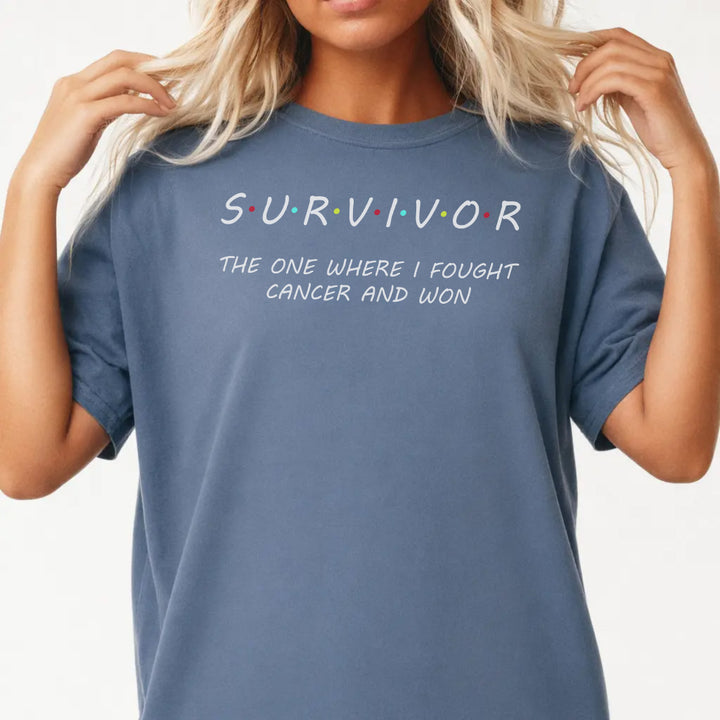 Woman wearing a blue jean Survivor graphic tee that reads The One Where I Fought Cancer and Won