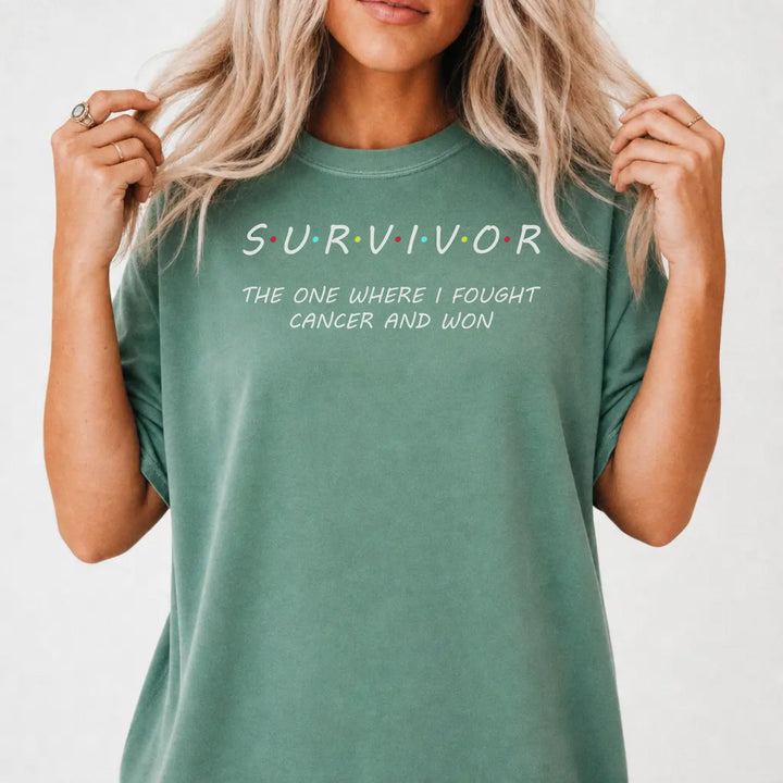 Woman wearing a light green Survivor graphic tee that reads The One Where I Fought Cancer and Won