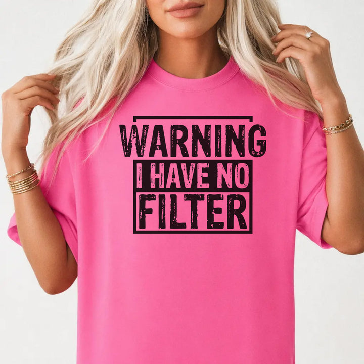 Woman wearing a neon pink shirt with bold distressed black lettering that reads Warning I Have No Filter on the front
