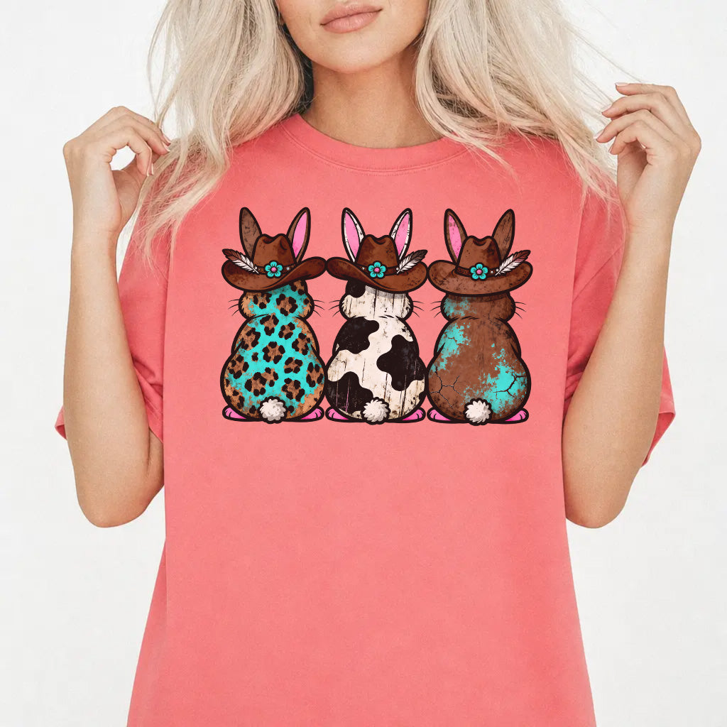 Woman wearing a watermelon shirt with three western Easter bunnies in cowboy hats featuring leopard cowhide and turquoise patterns on the front