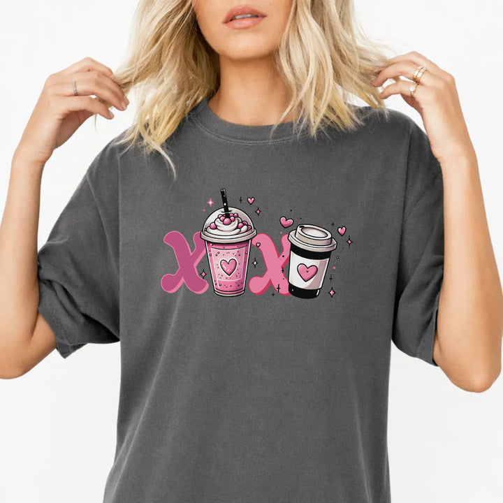 Woman wearing a pepper graphic tee with a pink XOXO coffee latte Valentine illustration on the front